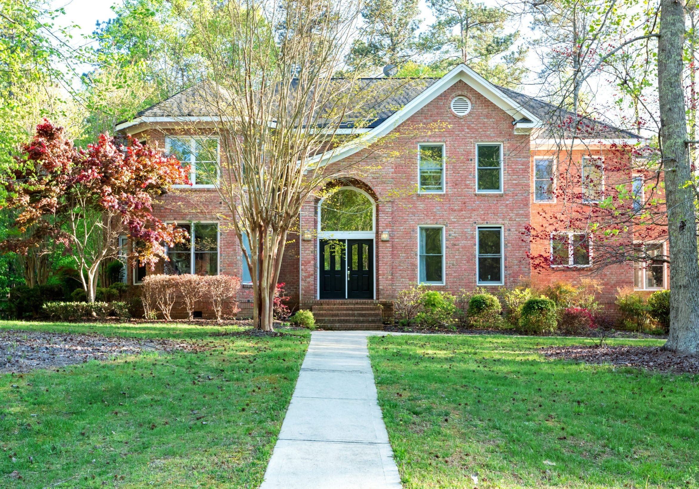 Luxurious large new brick residential home in spring time