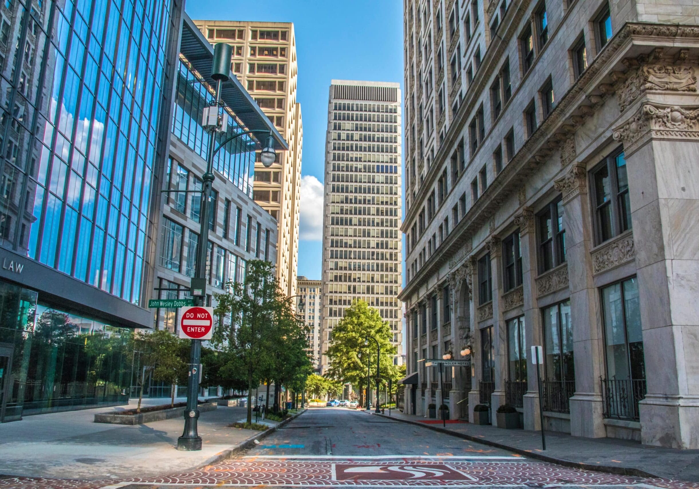 Downtown street lined with modern glass and historic stone buildings in the Atlanta suburb of Downtown Atlanta, Georgia.